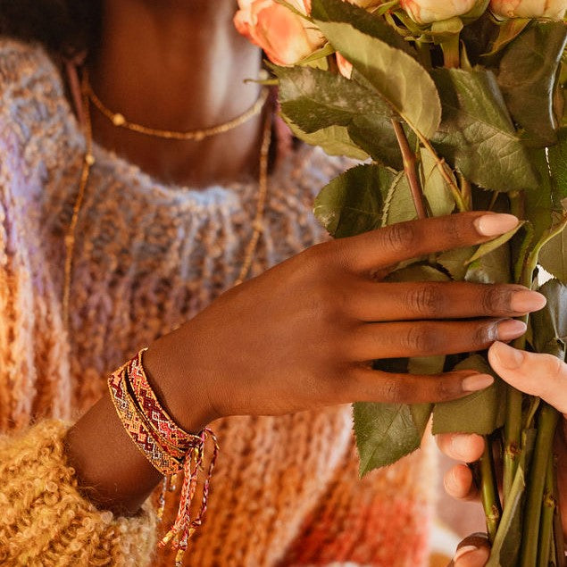 Model wearing the Glow Ember Bracelet from Love Is Project