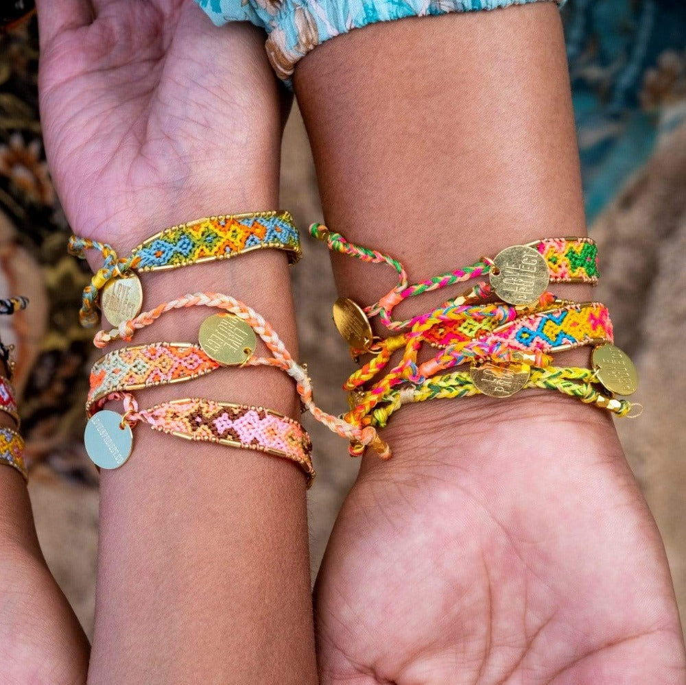 A model wearing the Aloha Bali Friendship Bracelet Stack from Love Is Project