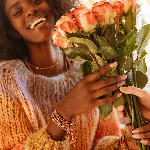 Model wearing the Glow Magma metallic friendship bracelet from Love Is Project