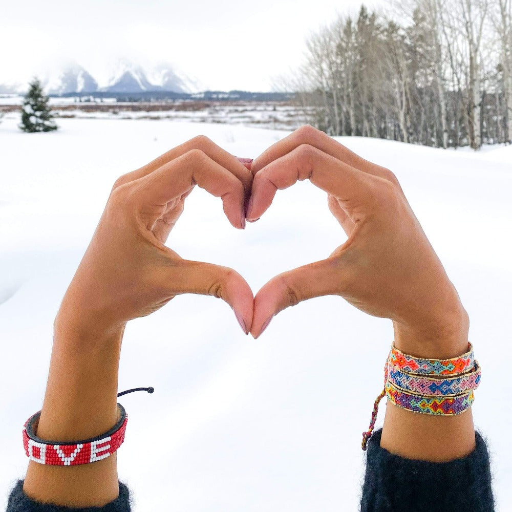 A model wearing the Dream Bali Friendship Bracelet Bundle from Love Is Project