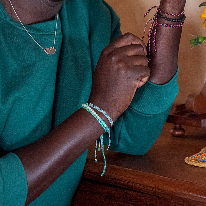 A model wearing some of the bracelets from the LoveStoned Collection from Love Is Project