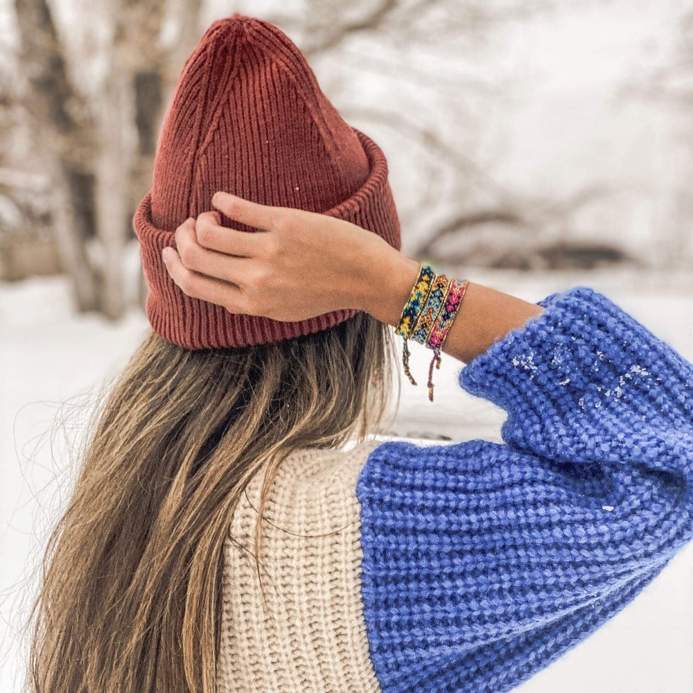 A model in the snow wearing the Coastal Bali Friendship Bundle from Love Is Project