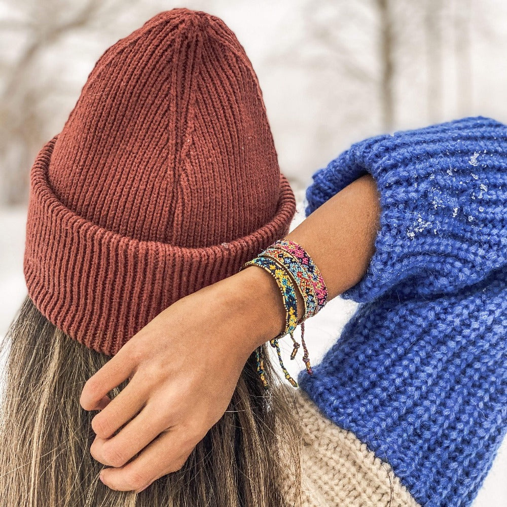 A model wearing the Shark Bali Friendship Bracelet Bundle from Love Is Project