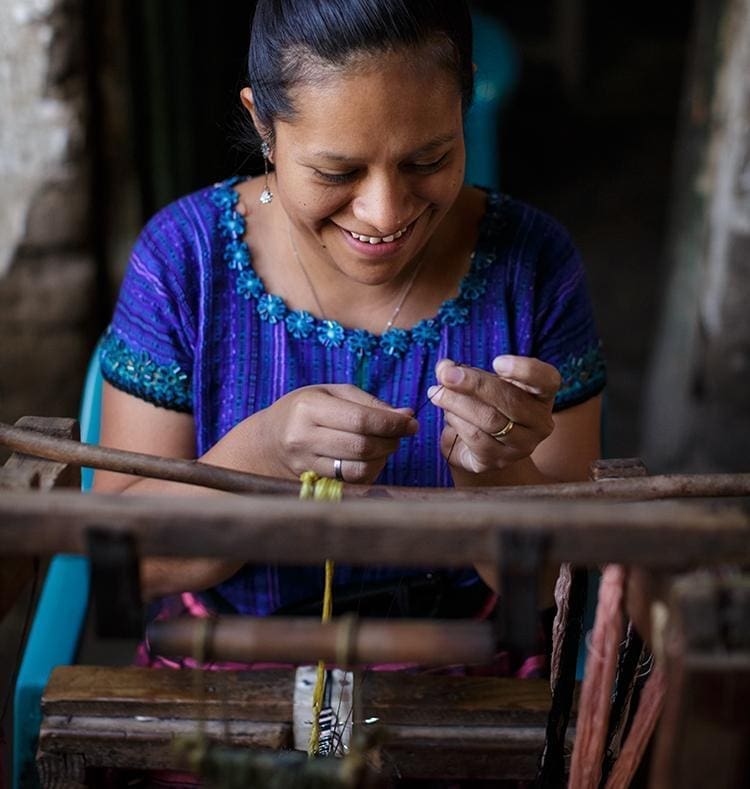 An artisan makes a Black and Neutral Atitlan LOVE Bracelet from Love Is Project