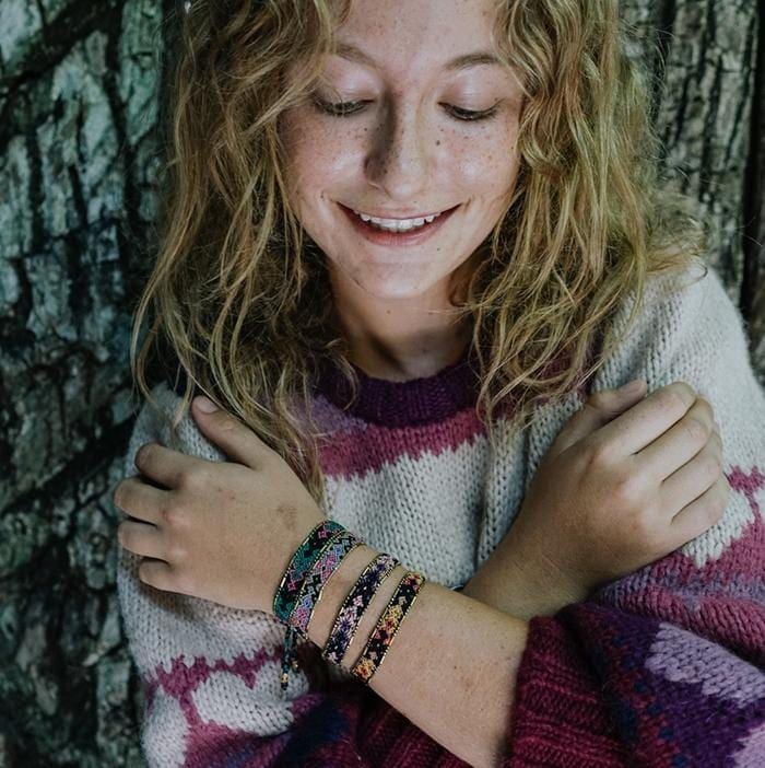 A model wearing the Galaxy Bali Friendship Bracelet Bundle from Love Is Project