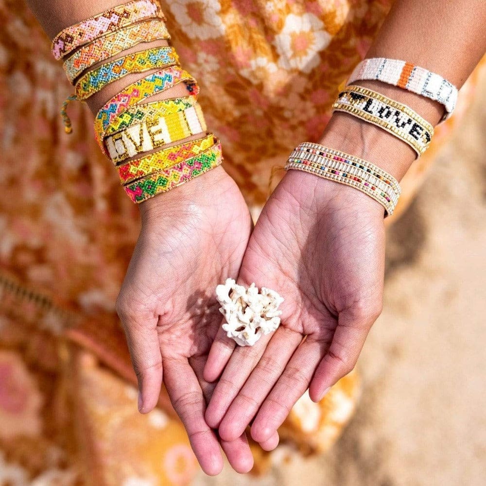 A model wearing the the Jungle Bali Friendship Bracelet Bundle from Love Is Project