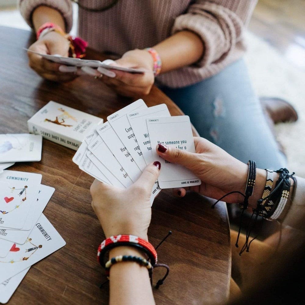 Friends playing with the Love Is Project Spread the Love Deck of Cards